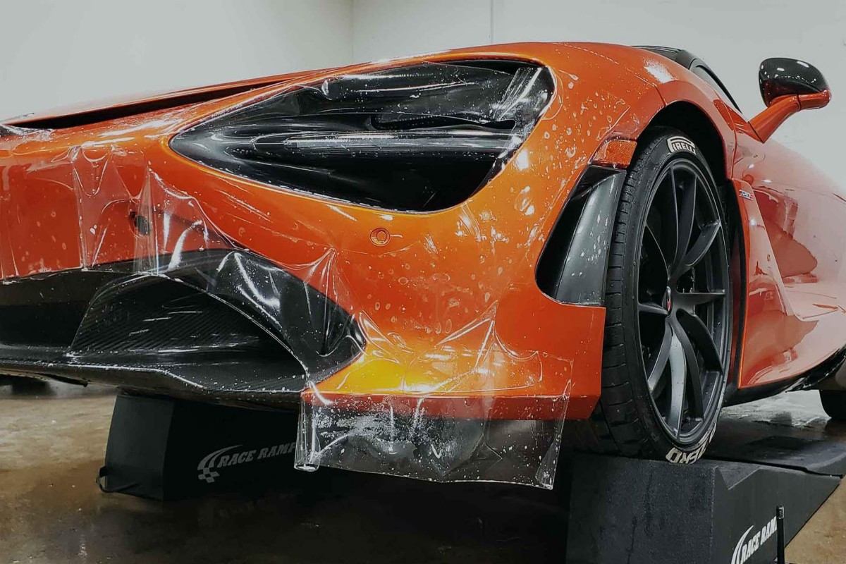 paint protection film being applied on luxury car body panel