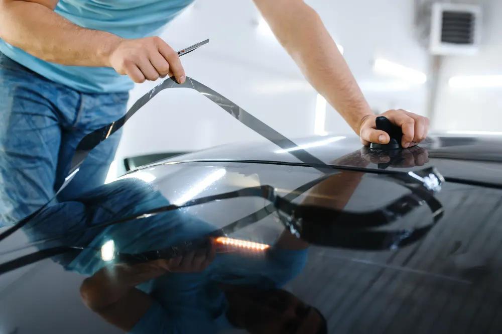 busy paint protection film shop with multiple vehicles being serviced daily