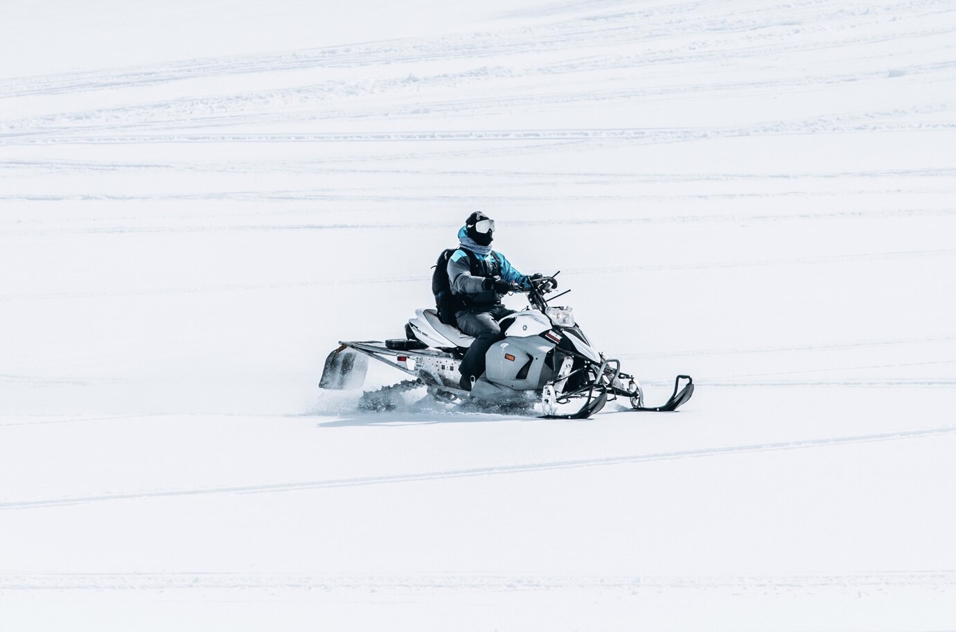 male-riding-snowmobile-large-snowy-field_181624-1940.jpg