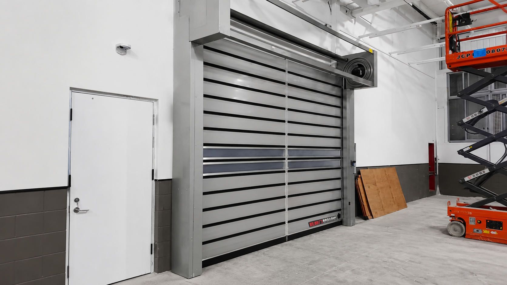 High-speed spiral door installed at a large industrial facility entrance