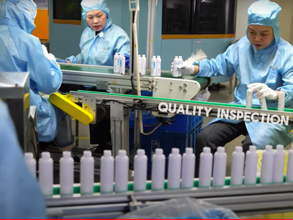 A cosmetic vacuum bottle production line at a factory, focusing on the manufacturing and quality control processes.png