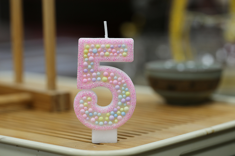 Sweet pink macaron balls decorated with digital modeling birthday candle