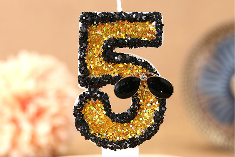 Creative black traced digital sunglasses adorn birthday candle