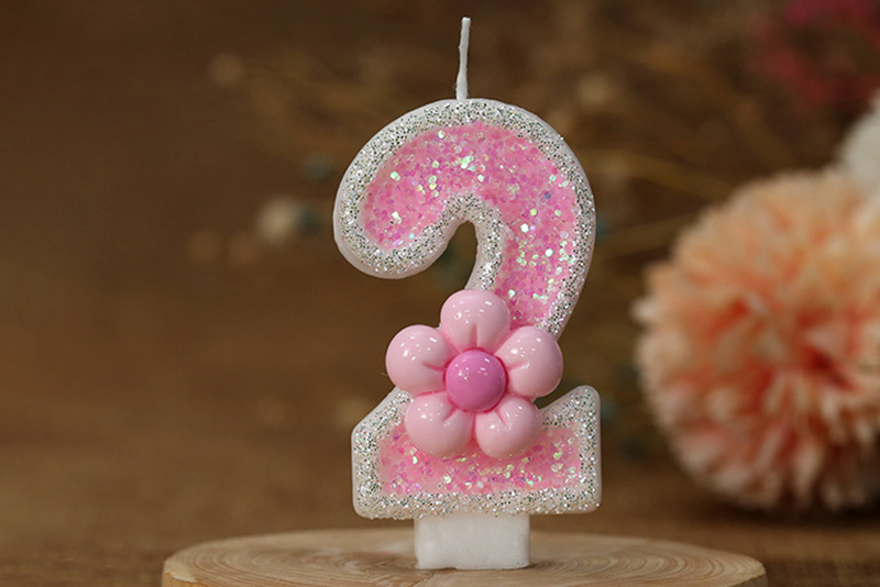 Creative pink flower decorations adorn digital birthday candle