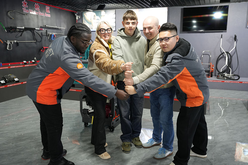 European visitors testing high pressure sewer jetter performance at AMJET factory.jpg