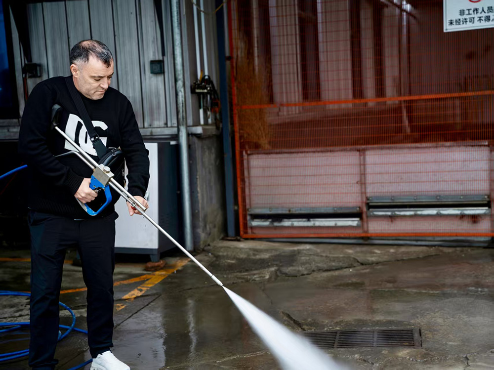 client testing high pressure sewer jetter machine with hose and spray gun.jpg