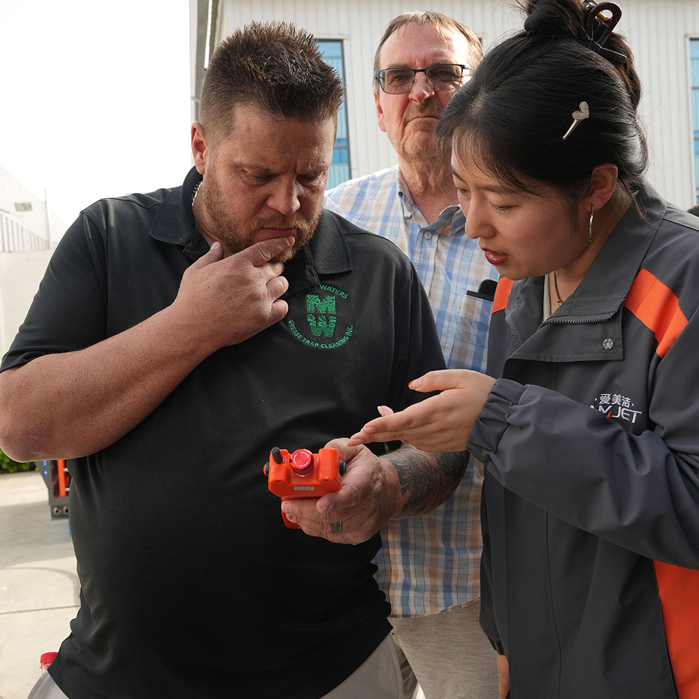 Customer inspecting Amjet Titan sewer jetter components during factory visit in China.jpg