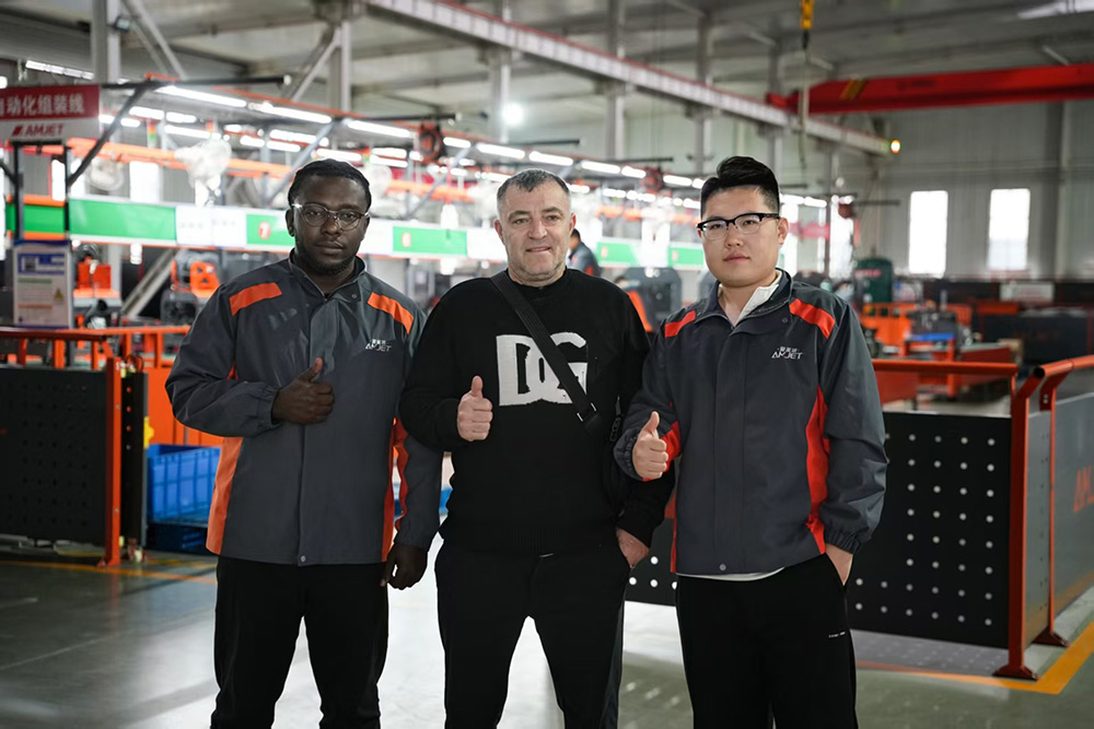 group photo of customers visiting Amjet factory for cooperation on sewer jetter machines.jpg
