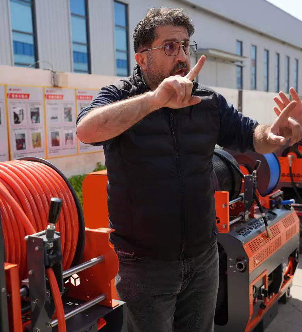 Technical discussion on 7250 PSI hot water pressure washer system at Amjet factory.jpg