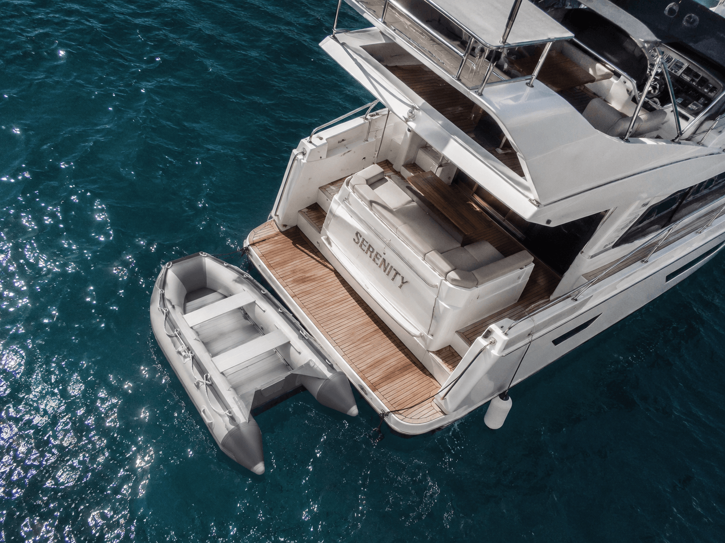 compact-inflatable-tender-for-yacht-garage.jpg  Alt Compact inflatable tender boat stored neatly inside luxury yacht tender garage.png