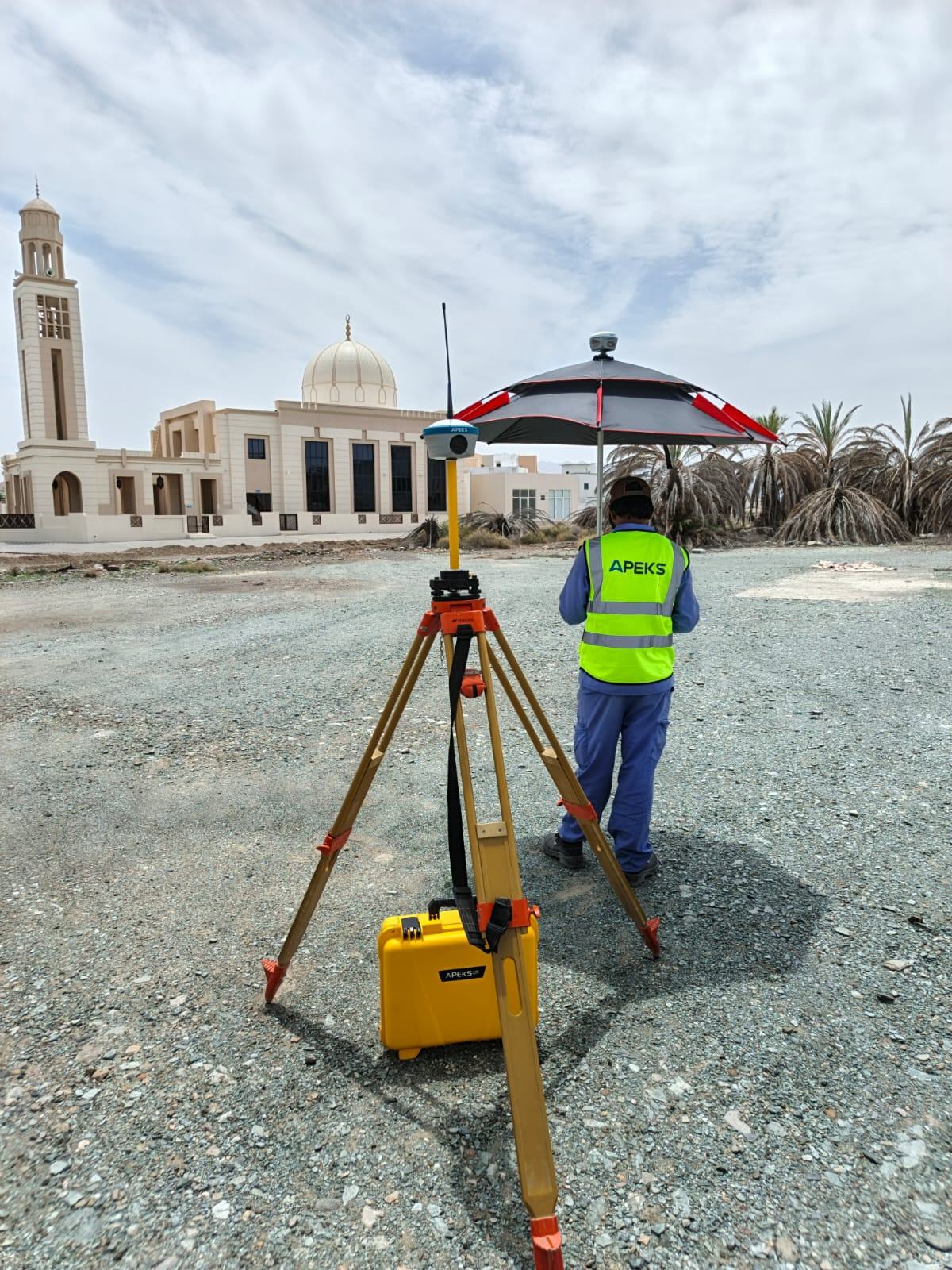 RTK GNSS survey team operating in Oman desert conditions during solar farm construction
