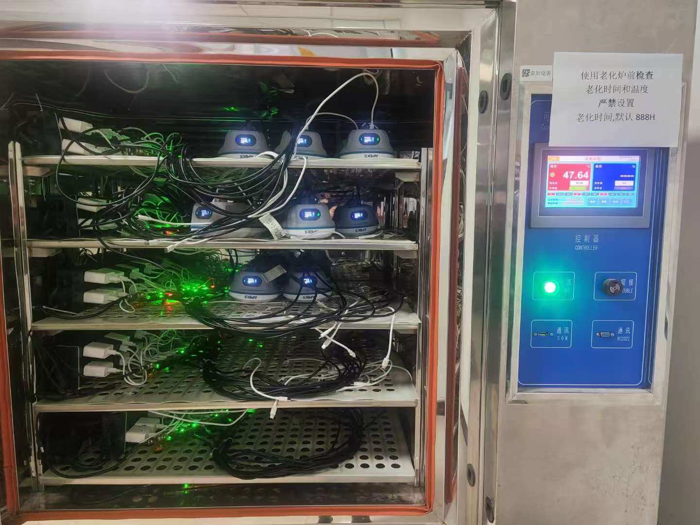 APEKS RTK GNSS receivers connected inside a burn-in thermal oven for high-temperature electrical aging and stress testing