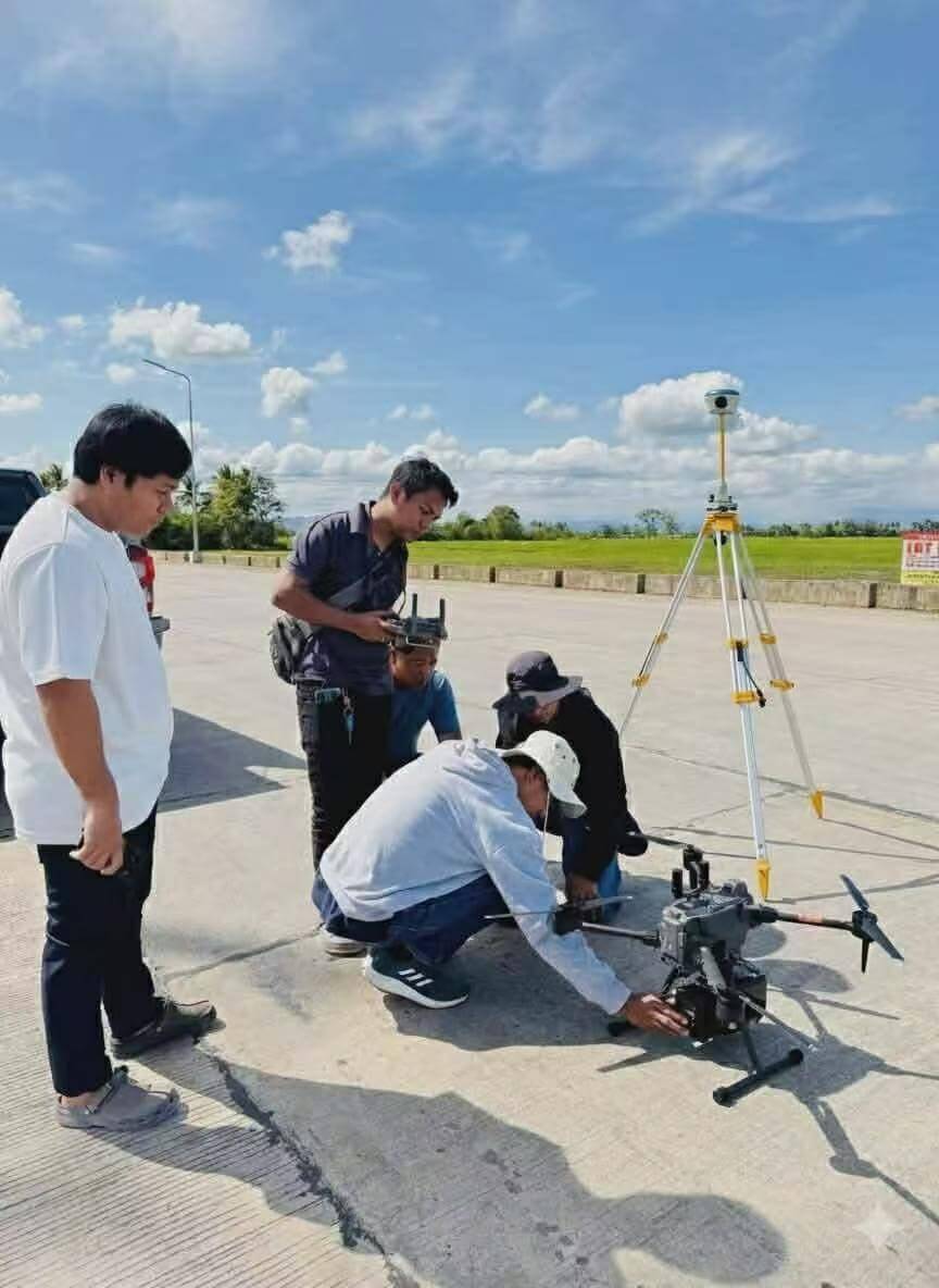 Field operators preparing a DJI Matrice enterprise drone paired with an APEKS MAX5 RTK base station for aerial LiDAR surveying