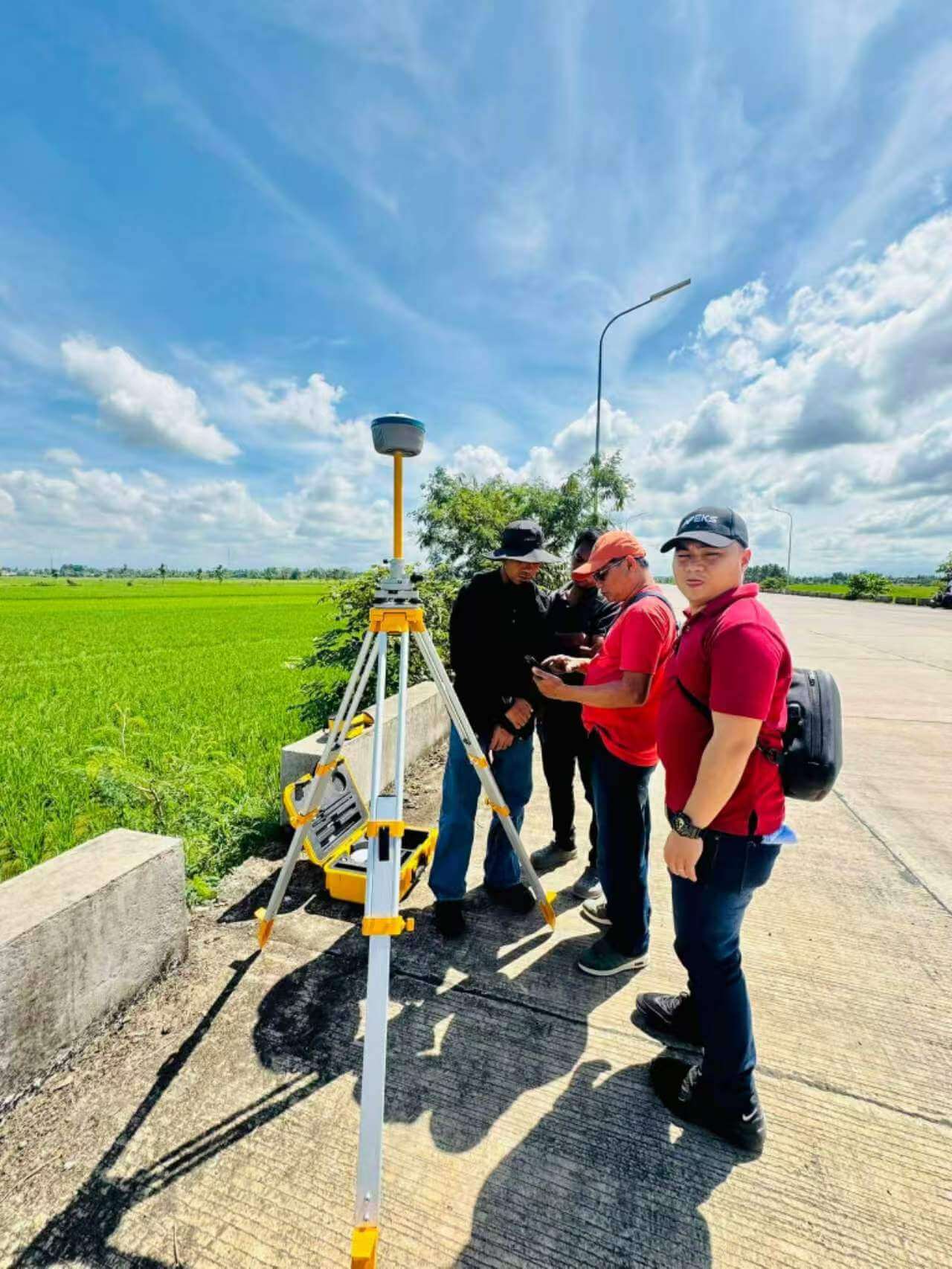 Survey team configuring the APEKS MAX5 base station along a rural road for agricultural aerial mapping