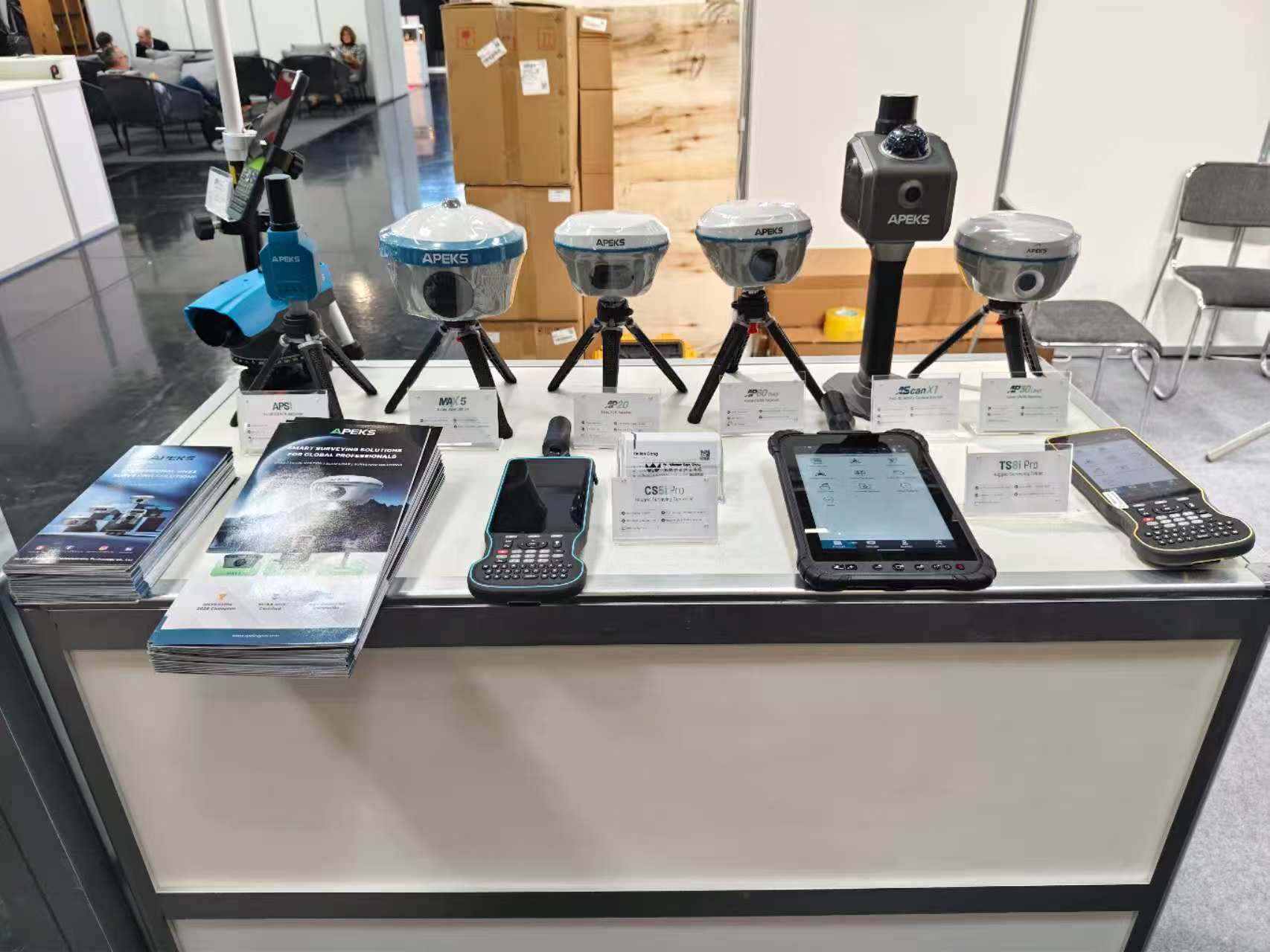 APEKS staff demonstrating GNSS receiver features to visitors at INTERGEO 2026