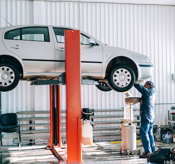 car-lifted-on-car-lift-for-routine-maintenance-F5DB9EQ