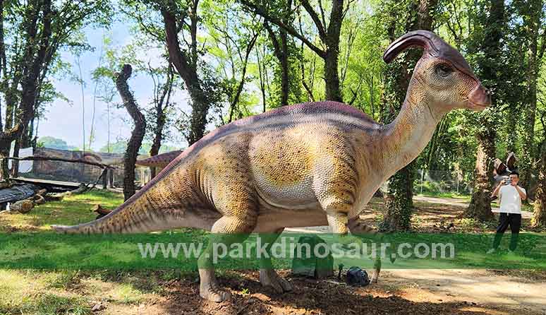 Herbivorous dinosaur model displayed in a forest clearing in Lugo