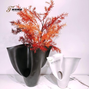 Abstract Curved Ceramic Vases: Black and White Artistic Home Decor with Vibrant Foliage