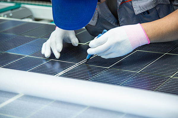 Worker inspect solar panel product