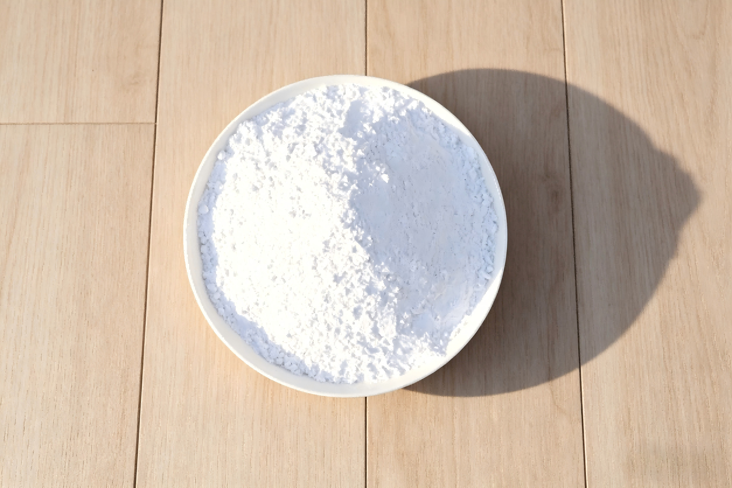 How is calcium carbonate utilized as an additive in lubricating greases?