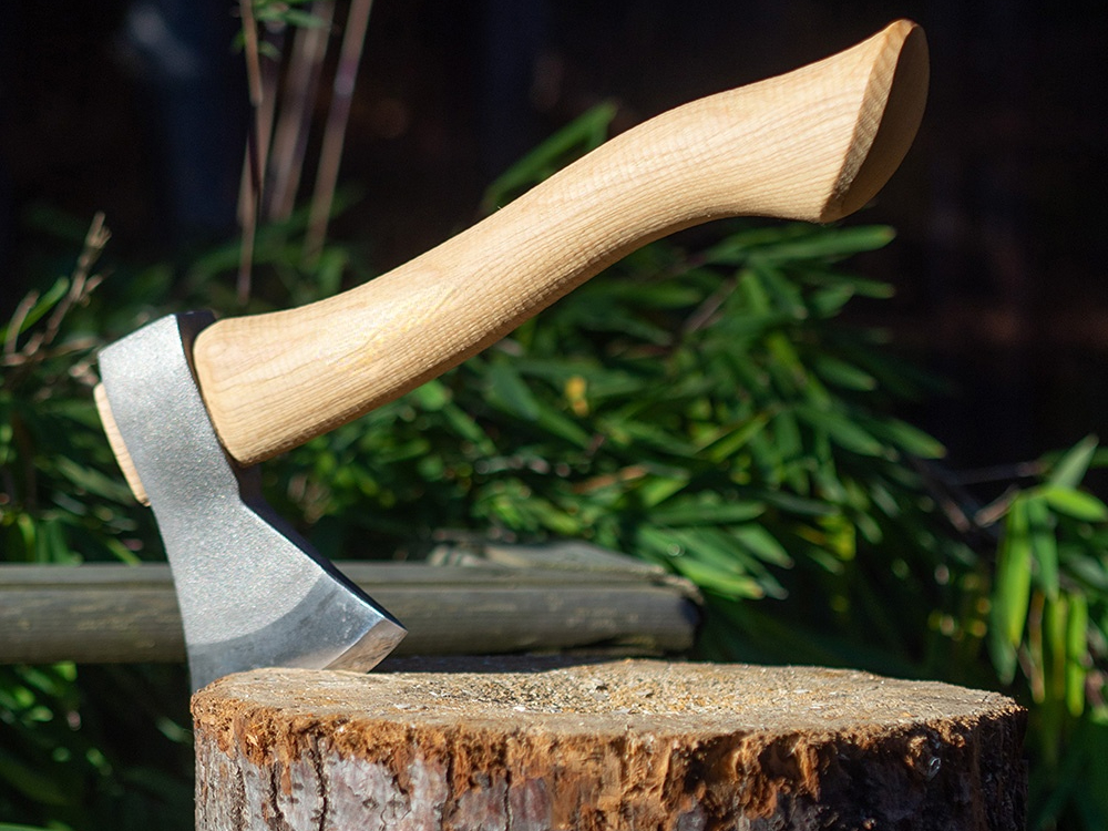 How much does an axe's material affect its chopping performance?