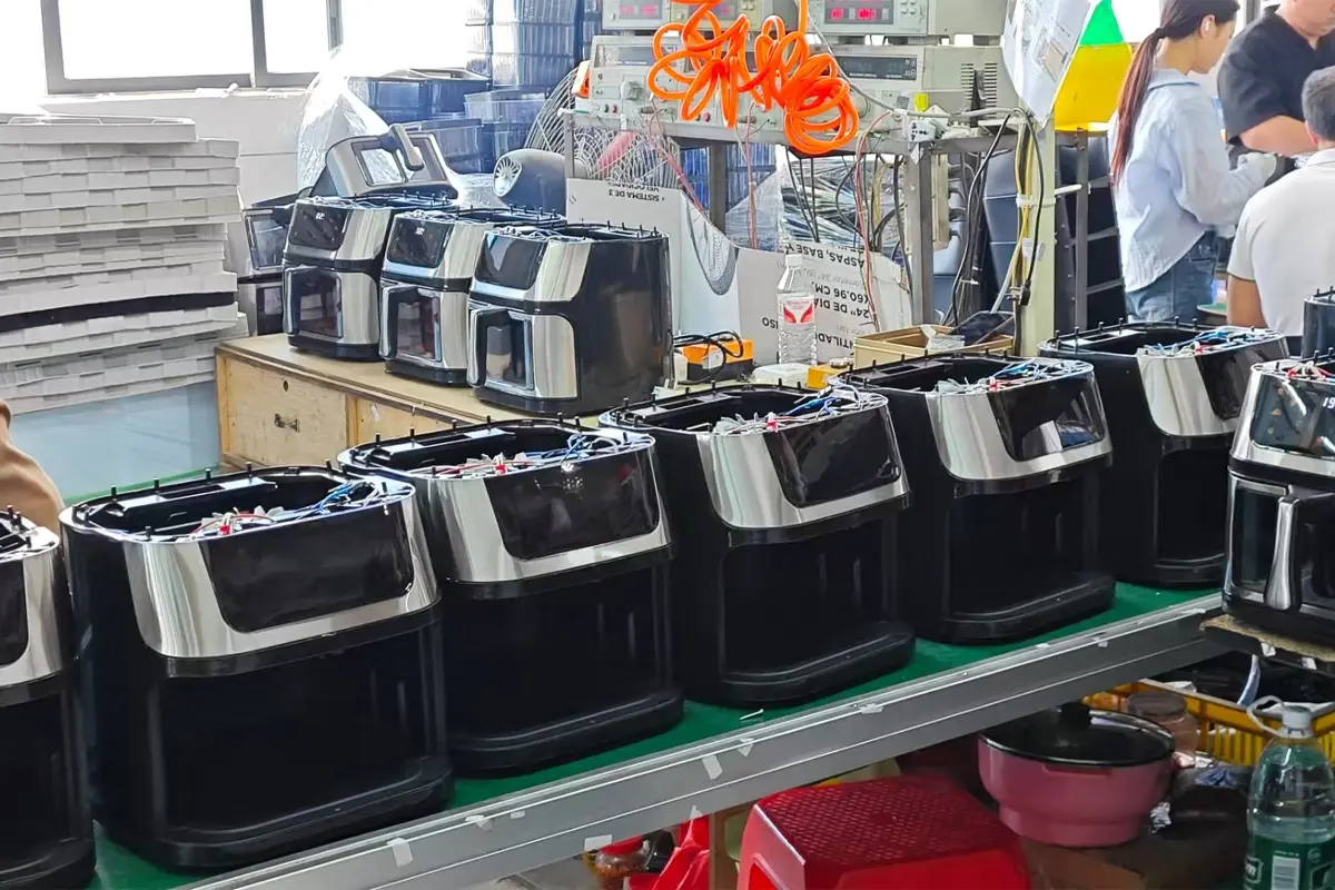 Air fryer units lined up on APEXDURA production assembly line before final handling