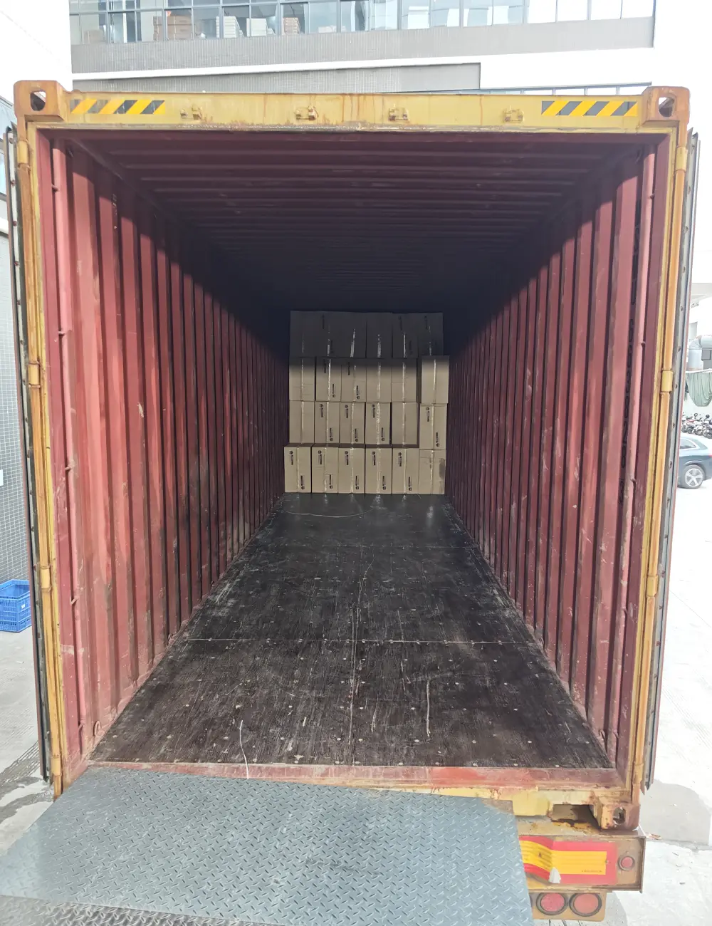 Partially loaded container interior with cartons stacked at the far end