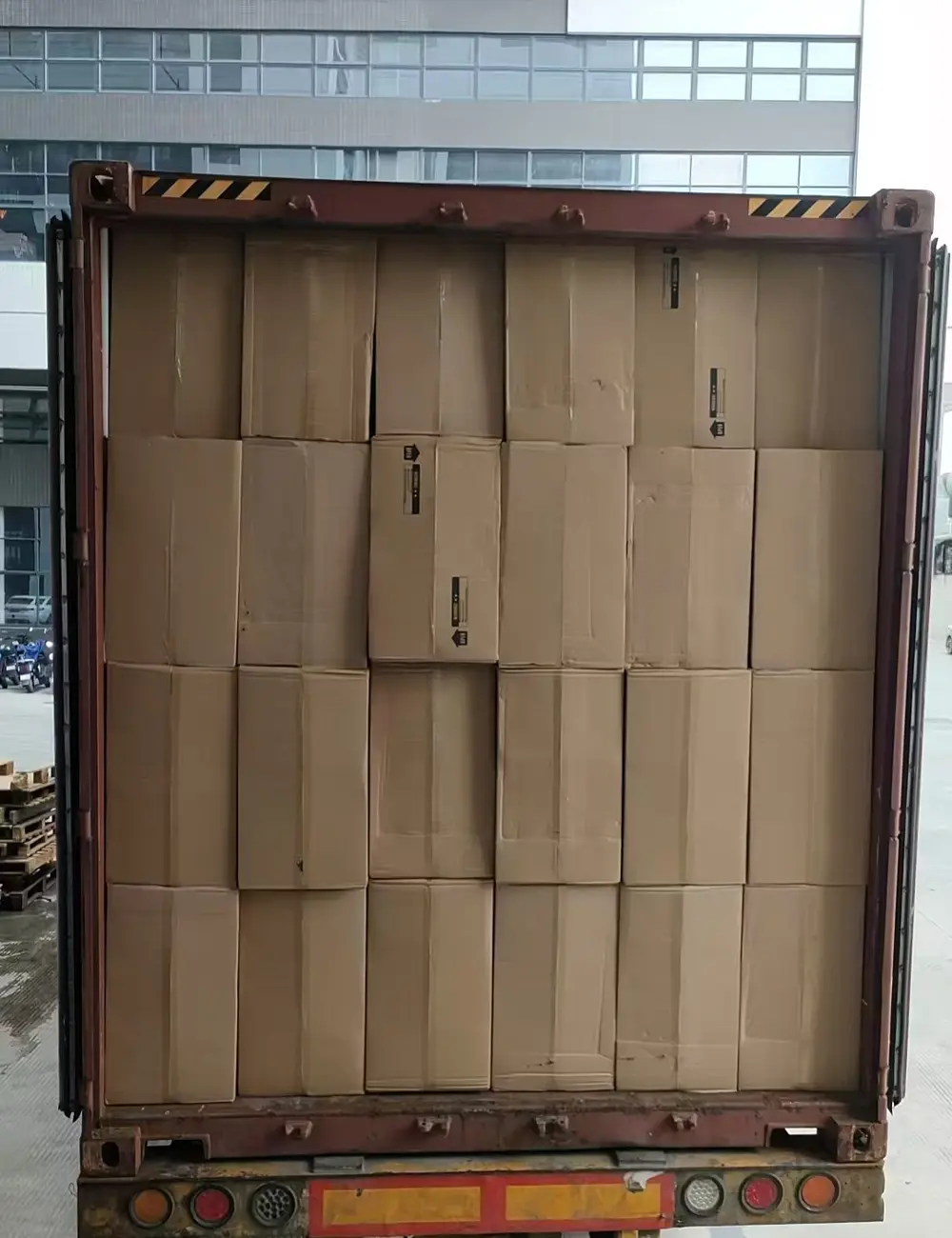 Fully loaded container front view showing tightly stacked appliance cartons