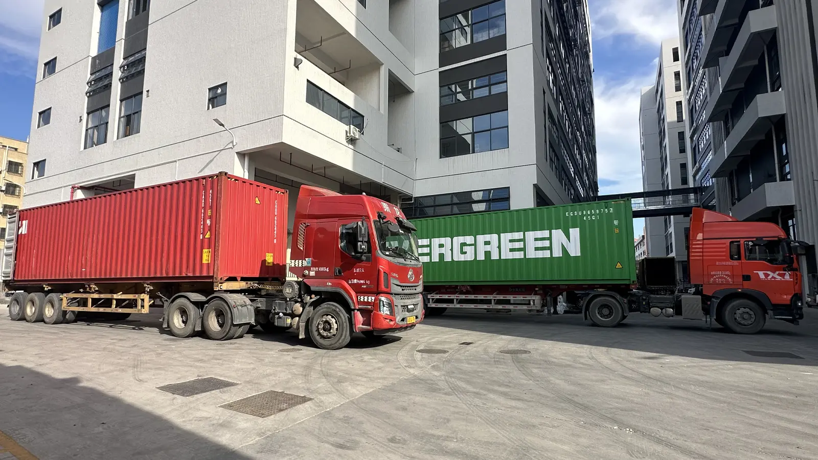 Multiple container trucks in APEXDURA factory yard during busy export dispatch