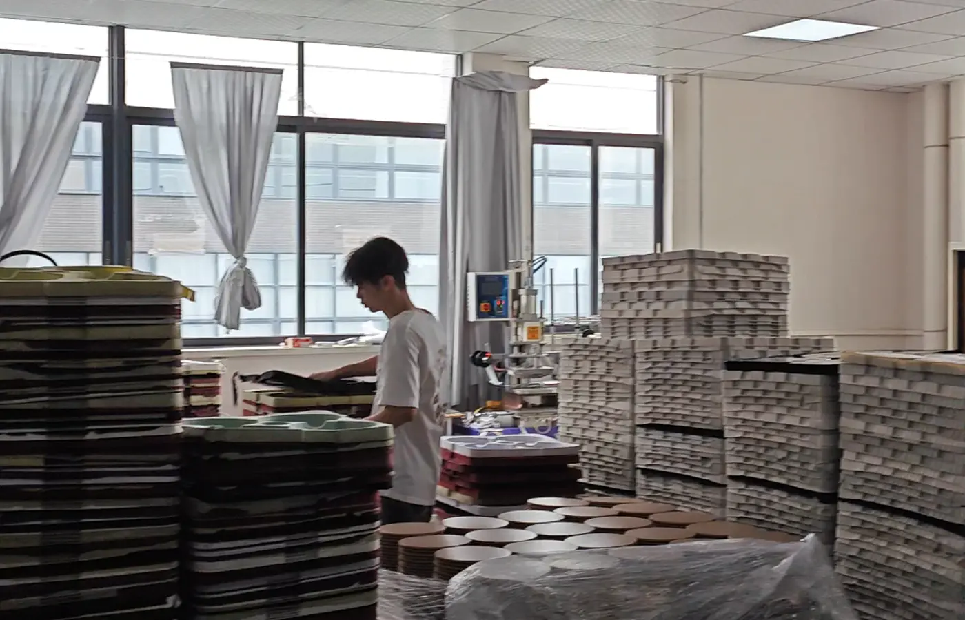 APEXDURA silk screen printing area with stacked appliance parts and trays