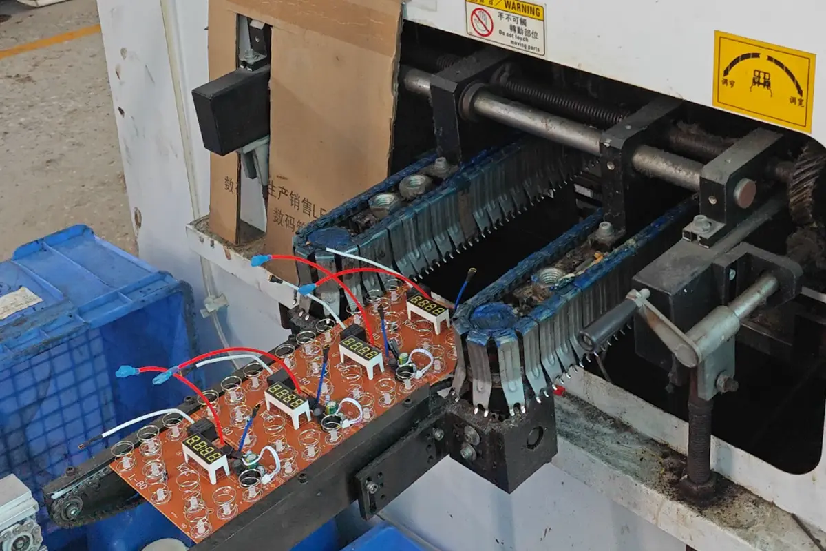 Circuit boards moving through soldering equipment in APEXDURA PCB workshop