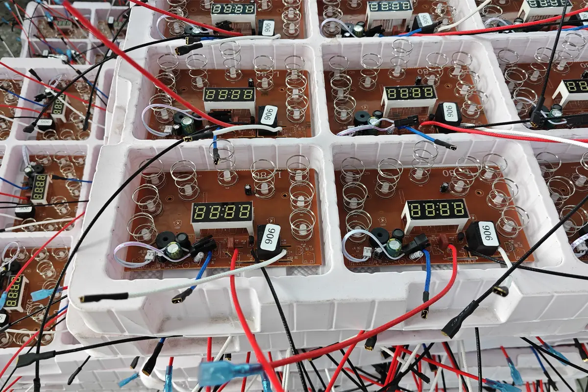 Kitchen appliance PCB trays with display modules, wires and terminals in APEXDURA workshop