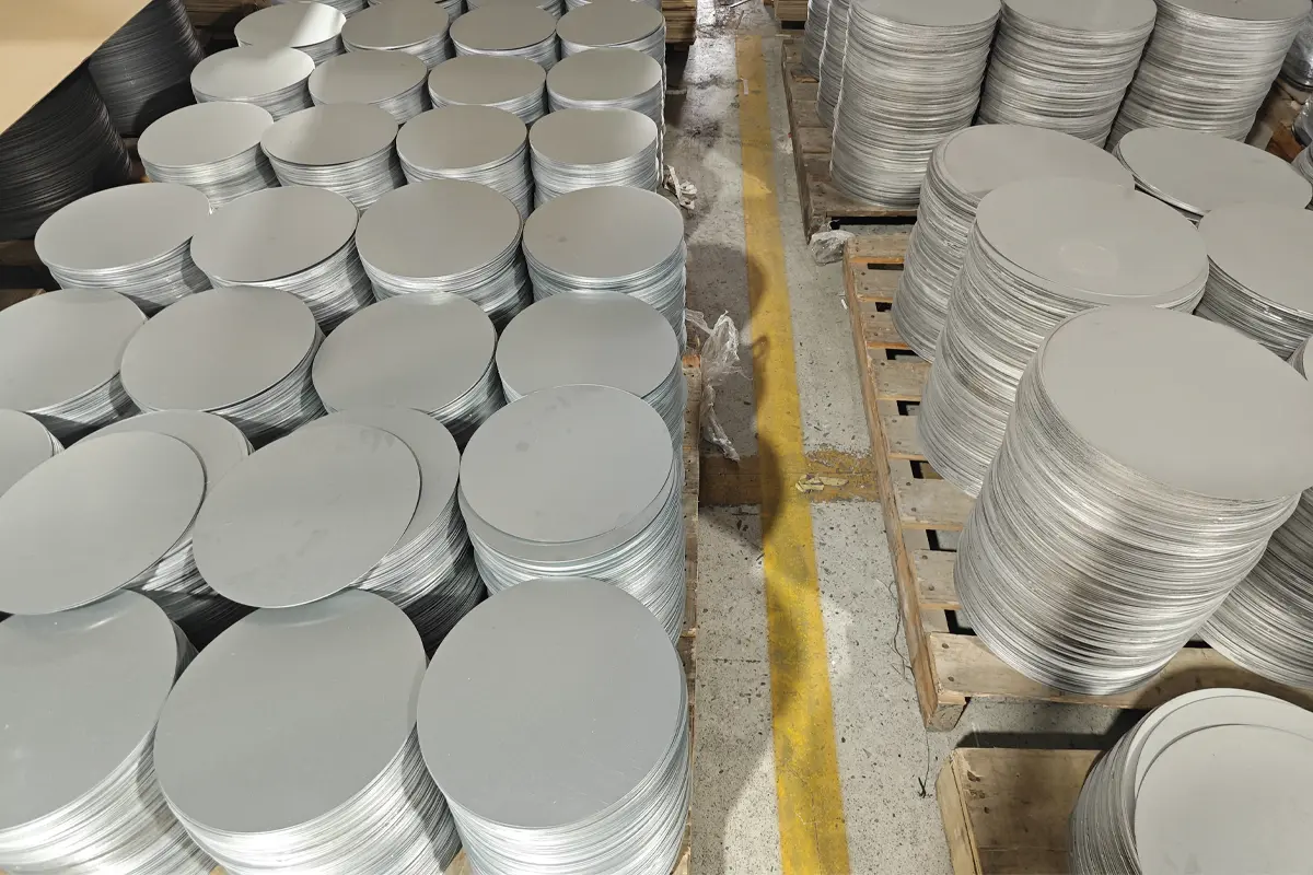 Stacks of round metal blanks prepared for appliance stamping production