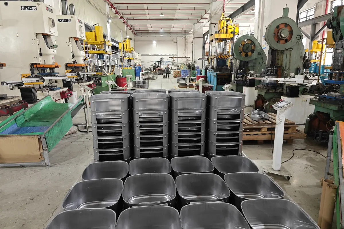 Stamped metal appliance baskets stacked in the metal stamping workshop before the next process
