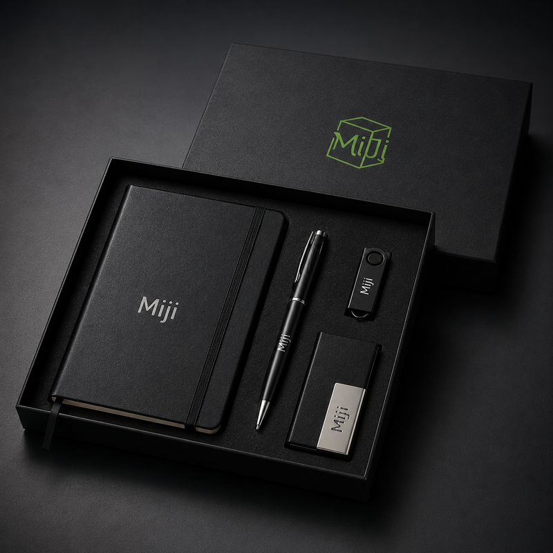Open black executive gift box with Miji notebook, pen, USB drive and card holder