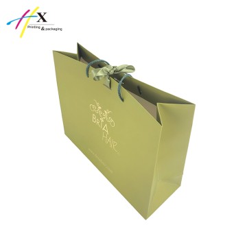 Green paper bag with gold logo for hair  