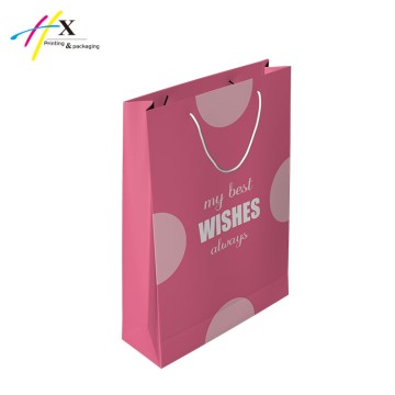 Holiday celebrating pink paper gift bag 